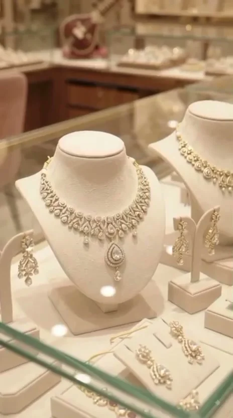 Diamond necklace and earrings displayed on an ivory bust